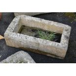 A weathered rectangular granite trough, 36 x 19in. (91.4 x 48.2cm.). * Has a crack on one side.