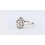An 18ct white gold and diamond ring, the pear shaped, pavé set cluster of ten brilliant cut diamonds