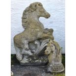 A stone figure of a rearing horse with ornate design, together with a weathered horse head, the