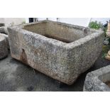 A large weathered rectangular granite trough, 57½ x 40in. (146 x 101.6cm.).