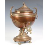 A George III copper samovar, of oval form, circa 1820, the lid with sphinx finial, the body with a