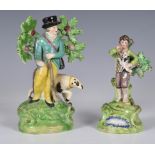 A 19th century Walton Staffordshire figure of a boy playing with a puppy, which he is carrying in