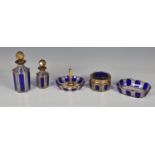 A late Victorian five piece blue and gold glass dressing table set, comprising of two perfume