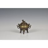 A Chinese bronze incense burner, with compressed body, pierced reticulated decoration to cover,