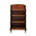 An early 19th century mahogany 'waterfall' bookcase, the arched back over four shelves with reeded