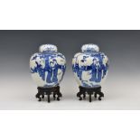 A pair of Chinese blue and white covered 'boys' jars, Kangxi four character marks to base but later,