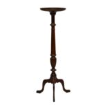A 19th century mahogany torchère, the dished top on turned and reeded column with splayed legs