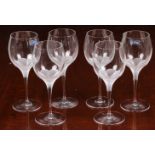 A boxed set of six Sevres crystal wine glasses, each with frosted flower detail to top of stem,