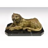 A contemporary polished bronze sculpture of a recumbent tiger, raised on shaped rectangular black