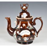 A Victorian barge ware teapot, inscribed "Think of Me", the stoneware body with typical treacle