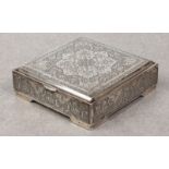 A Persian silver lidded box, probably early 20th century, of square form, chased with a large floral