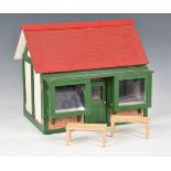 A scratch built dolls house in the form of a bay window cottage, the roof lifts off, the front