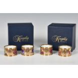 Two boxed pairs of Kingsley Enamels napkin rings by S. Smith, hand painted in enamels with fruit,