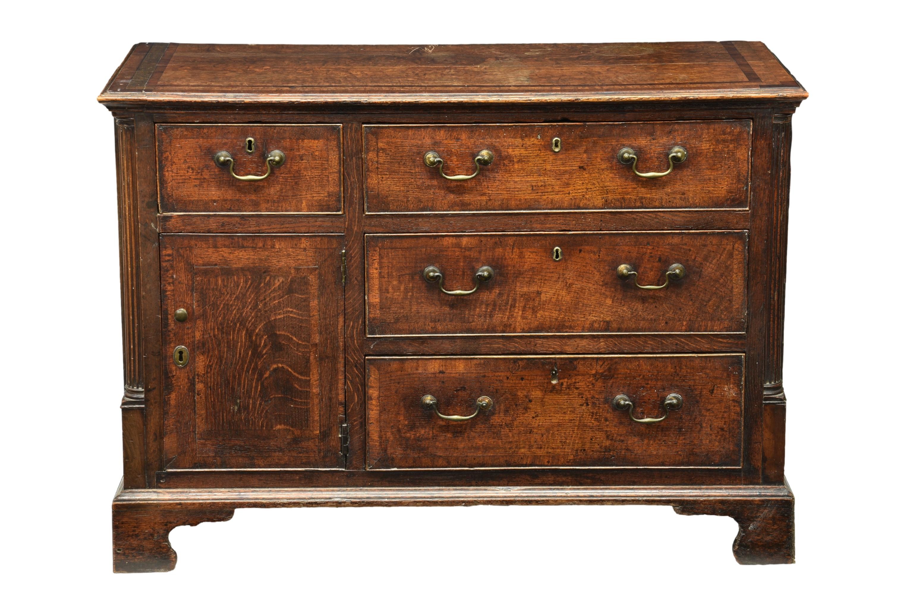 A George III mahogany-cross-banded oak chest of drawers, the rectangular top over a single short