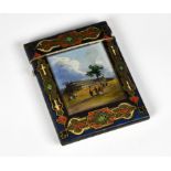 A Victorian papier-mâché souvenir card case, the front panel with bevelled glass cover, printed &