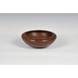 A turned Honduras mahogany bowl, signed beneath "T.F. Holland", 7½ in. (19cm.) diameter., 2¾in. (