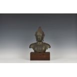 A Sino-Tibetan verdigris bronze bust of Buddha mounted on a wooden plinth, probably 19th century,