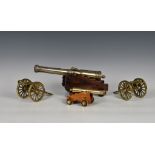 A pair of miniature polished bronze / brass field cannon models, 8¼in. (21cm.), together with two