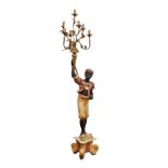 A 19th century painted and parcel gilt blackamoor style floor standing candelabra, second half