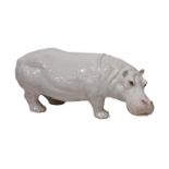 A large white glazed Italian terracotta hippopotamus, having realistic features, modelled in a