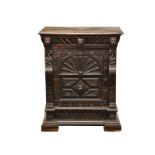 A Victorian carved oak side cabinet, the two plank top over a concealed frieze draw with