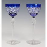 Two Bohemian cobalt blue crystal glass wine / hock glasses, shaped foot to hexagonal tapering