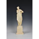 An alabaster figure of a classical maiden, carved in standing position, draped in cloak, holding a