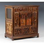 A Chinese carved hardwood table cabinet, probably 19th century, the panelled top over a pierced five