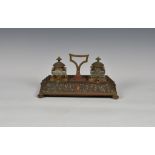 A 19th century embossed copper desk stand, of rectangular form, the sloping edges embossed with