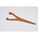 A pair of late 19th century novelty carved boxwood glove stretchers, probably French, the