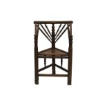 An early 19th century oak turner's chair, height to seat 18¾in. (47.6cm.). * Condition: Some chips