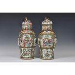 A closely matched pair of 19th century Chinese Canton famille rose covered vases, the vases of