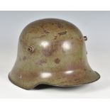 An original WWI First World War Imperial German Army steel combat helmet, painted green, with twin