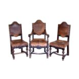 A set of four carved oak and leather chairs, early 20th century, comprising an open armchair and