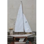 A large wooden pond yacht, having weighted keel, painted white hull with red trim, faux plank