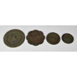 Four Chinese bronze mirrors, probably Sui or Tang Dynasty, to include three of circular shield form,