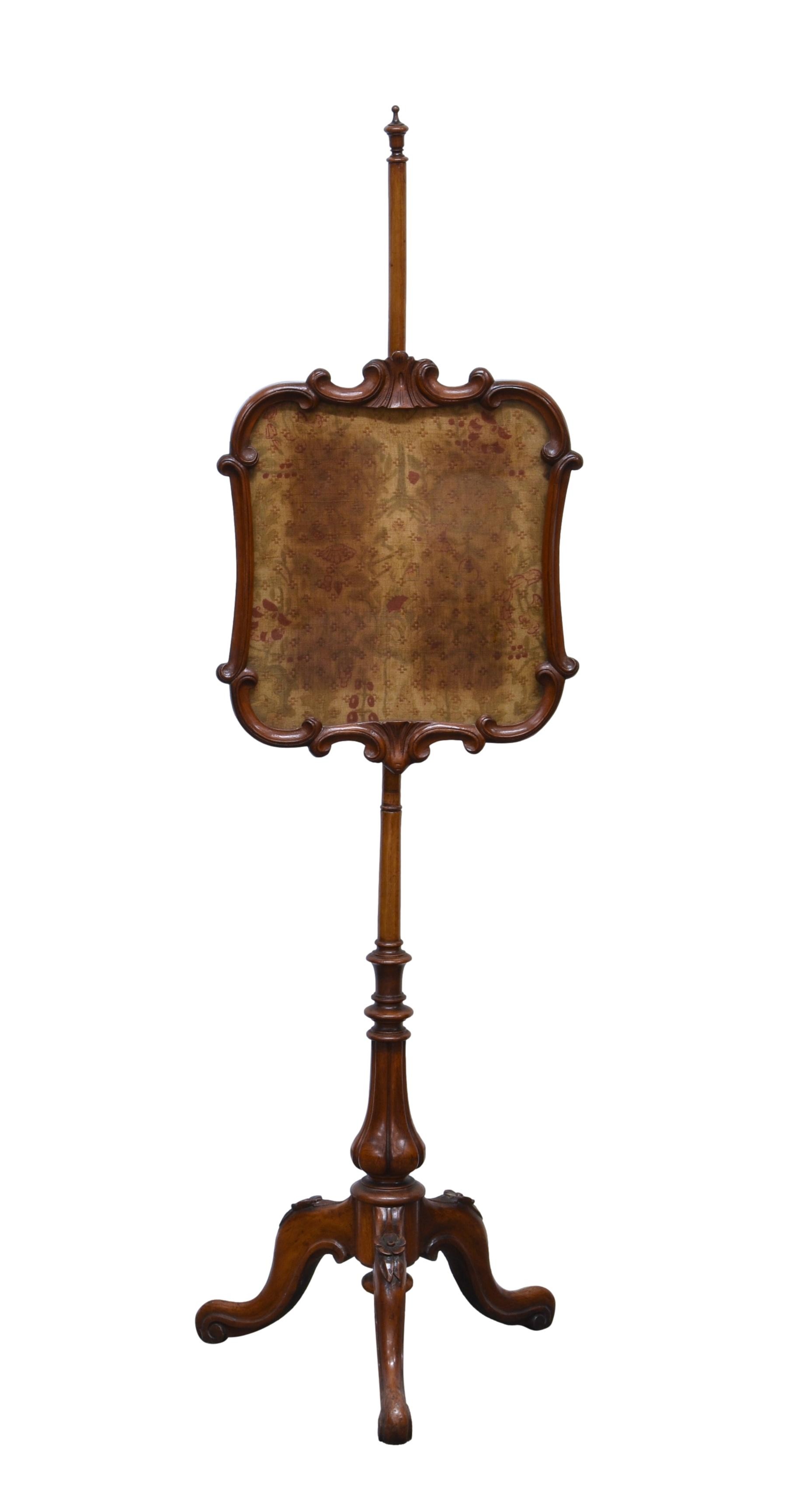 A Victorian mahogany pole screen, with floral embroidery within the shaped screen, on a turned