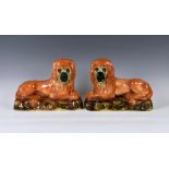 A pair of antique Scottish Bo'ness Pottery recumbent lions, mantel/fireside ornaments, 13in. (33cm.)