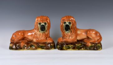 A pair of antique Scottish Bo'ness Pottery recumbent lions, mantel/fireside ornaments, 13in. (33cm.)