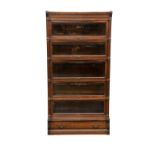 An early 20th century Globe Wernicke modular oak bookcase, the moulded top over a dentil cornice