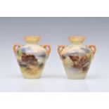 A pair of Royal Worcester porcelain highland cattle painted twin handled vases by Harry Stinton, one