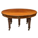 A fine late Victorian mahogany circular extending dining table with leaf holder by Edwards and