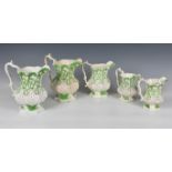 A graduated set of four Victorian relief moulded jugs, of octagonal form, decorated with stylised