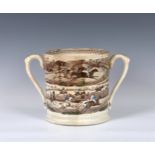 A 19th century twin handled loving cup of large proportions, transfer printed and hand coloured,