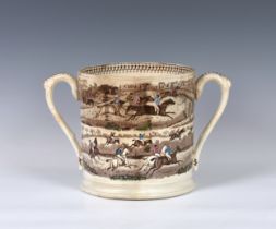 A 19th century twin handled loving cup of large proportions, transfer printed and hand coloured,