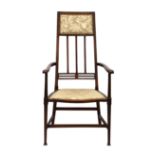 An Edwardian mahogany and satinwood high back open armchair, the slightly tapered, rectangular