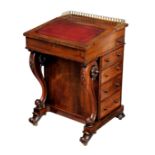 An early Victorian rosewood Davenport, the top with gilt brass three quarter gallery over a gilt