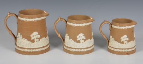 Three Victorian Copeland Late Spode graduated jugs, buff stoneware with sprigged relief decoration
