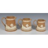 Three Victorian Copeland Late Spode graduated jugs, buff stoneware with sprigged relief decoration
