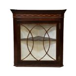 A George III inlaid mahogany glazed corner cabinet, the moulded and banded cornice over a boxwood